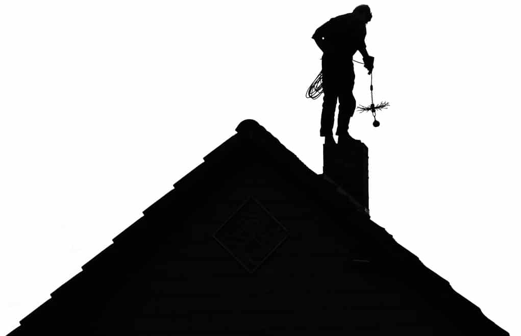 Chimney Sweep Silhouette at work on the roof