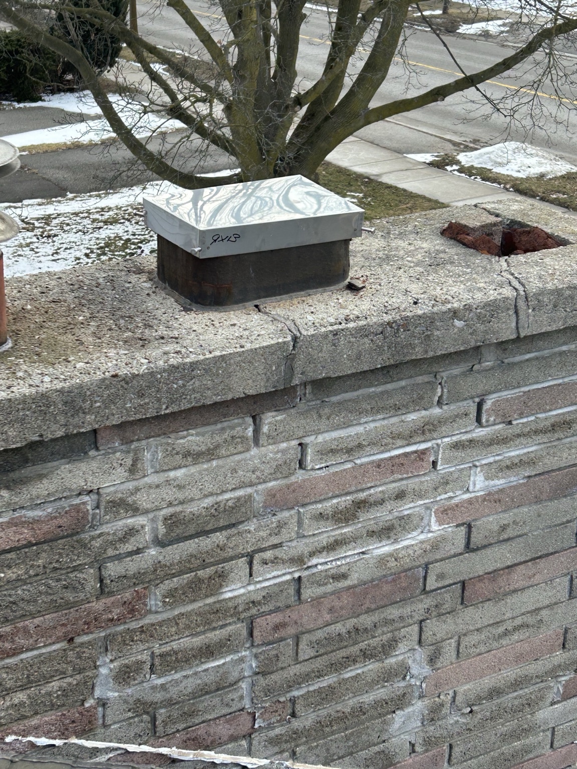 Cracked chimney crown showing deterioration found during WETT inspection in Caledon